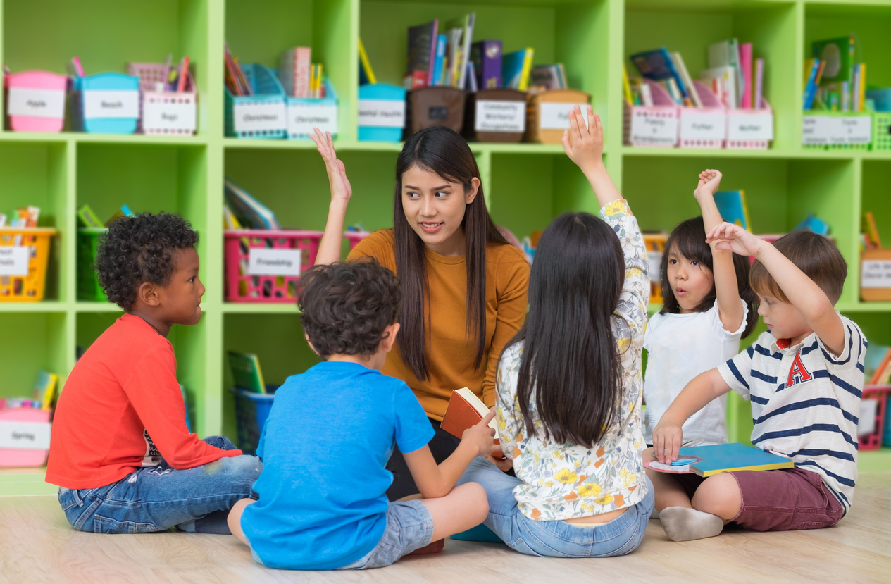 Asian teacher teaching and mixed race kids hand up to answer in classroom,Kindergarten pre school concept. | Center for Integrated Training & Education