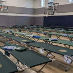 Seven school gyms are housing migrants or could soon. Parents and pols are pushing back.