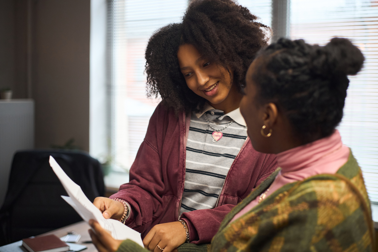 Two school leaders reviewing documents together in an office