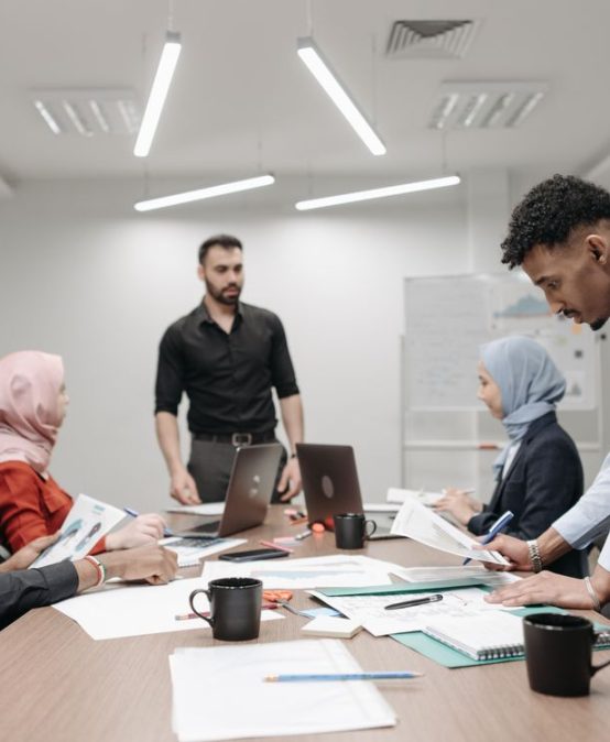 Diverse school leaders planning around a conference table